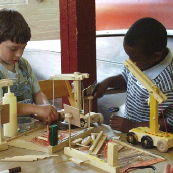 Students at work building trucks as part of a vacation program