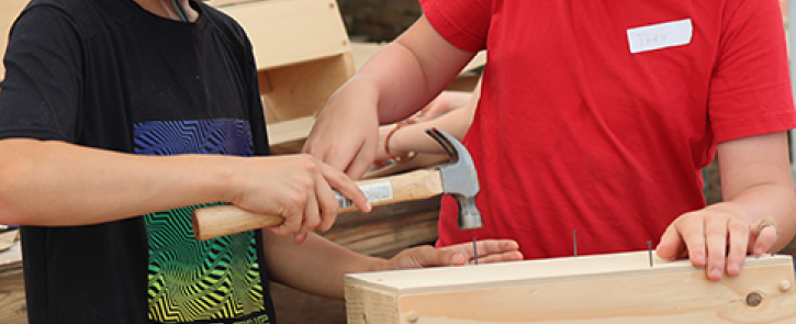 Two kids building a toolbox.