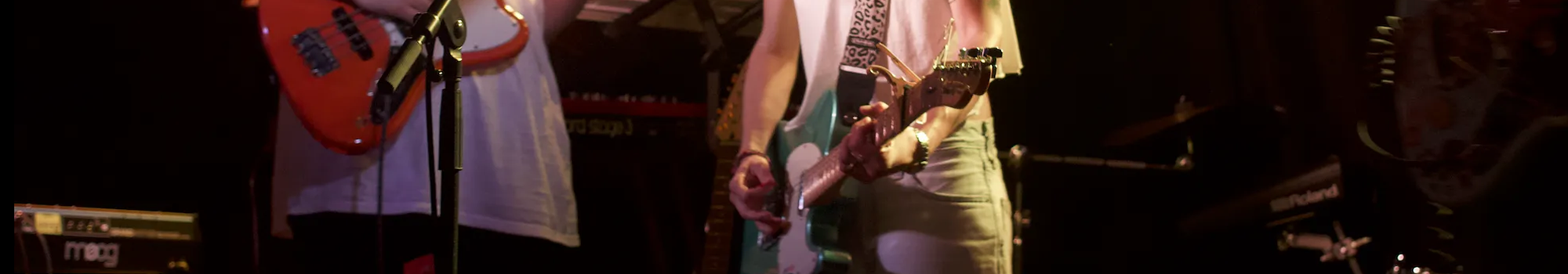 Brooke Dougan and bandmate playing electric guitars.